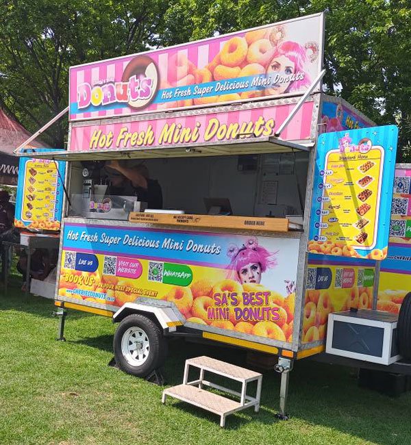 Cherie’s Mini Donuts trailer serving hot fresh mini donuts at a sports day